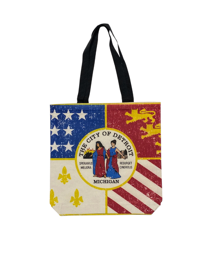 Natural canvas tote bag with a vintage distressed City of Detroit flag print and black straps by Ink Detroit